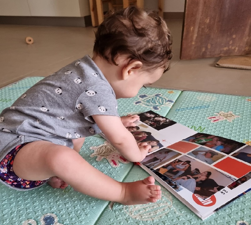 איך מעצבים אלבום דיגיטלי למשפחה, תינוק מסתכל על אלבום משפחה